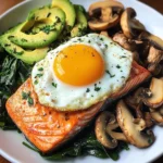 Pan-Seared Salmon with Sunny Egg, Sautéed Spinach, Mushrooms & Avocado